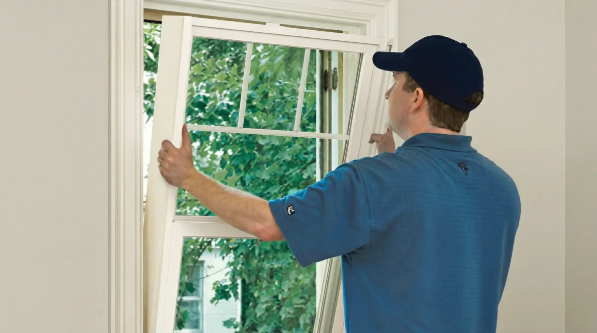 Professional contractors performing a residential window insulation and replacement service in Ann Arbor, Mi